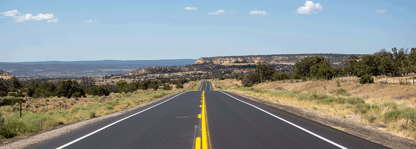 Open road with mountains in the background.